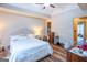Spacious bedroom with a tray ceiling, wood floors, and plenty of natural light at 402 Stonebrooke Dr, Auburn, GA 30011