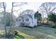 Charming home with a front porch, attached garage and nicely manicured lawn and mature trees at 402 Stonebrooke Dr, Auburn, GA 30011