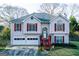 Charming home featuring red shutters, a well-manicured lawn, and a two-car garage at 402 Stonebrooke Dr, Auburn, GA 30011