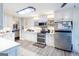 Spacious kitchen with stainless steel appliances, white cabinets and modern fixtures at 402 Stonebrooke Dr, Auburn, GA 30011