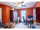 Home office with ceiling fan, built-in cabinets, and a large window at 402 Stonebrooke Dr, Auburn, GA 30011
