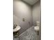 The small bathroom features modern fixtures and stylish marble-look flooring at 7560 Taylor Rd # 1, Riverdale, GA 30274