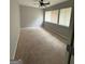 Neutral-colored bedroom with a ceiling fan and ample natural light from two large windows at 7560 Taylor Rd # 1, Riverdale, GA 30274