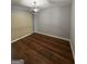 Bedroom with hardwood flooring, sliding door, and modern light fixture at 7560 Taylor Rd # 1, Riverdale, GA 30274