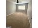 Neutral bedroom with carpet, ceiling fan and window offering natural light at 7560 Taylor Rd # 1, Riverdale, GA 30274