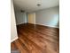 Living room features hardwood floors, neutral walls, and sliding glass door at 7560 Taylor Rd # 1, Riverdale, GA 30274