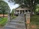 Charming one-story home featuring a covered front porch and landscaped yard with a mature shade tree at 212 Little Se St, Atlanta, GA 30315