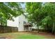 Exterior view of home shows backyard, deck, privacy fence, and mature trees at 2009 Parador Aly, Mcdonough, GA 30253