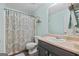 Bathroom with patterned shower curtain, sink with vanity, and updated features at 2009 Parador Aly, Mcdonough, GA 30253