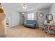 Bright bedroom features a blue sofa, neutral walls, beige carpet, and ceiling fan at 2009 Parador Aly, Mcdonough, GA 30253