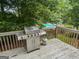 Deck features a stainless steel BBQ grill, wood railings, and distant pool view at 2009 Parador Aly, Mcdonough, GA 30253