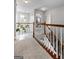 Well-lit hallway with wooden railing, carpeted floor runner, and views of the house at 2009 Parador Aly, Mcdonough, GA 30253