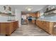 Bright kitchen featuring wooden cabinets, stainless steel appliances, and wood-look flooring at 2009 Parador Aly, Mcdonough, GA 30253