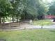 Inviting backyard retreat featuring a hot tub, seating area, and play structure nestled among mature trees at 3025 Ebenezer Rd., Se Rd, Conyers, GA 30094
