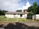 Backyard view of the house, featuring a fenced yard and a chimney at 3025 Ebenezer Rd., Se Rd, Conyers, GA 30094