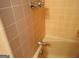Close-up of the salmon colored tiled bath tub and surround at 3025 Ebenezer Rd., Se Rd, Conyers, GA 30094
