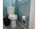 Bathroom featuring vintage turquoise tiles, mosaic floors, a toilet, and a trash can at 3025 Ebenezer Rd., Se Rd, Conyers, GA 30094