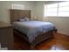 Cozy bedroom with a large bed, hardwood floors, neutral colors, and natural light at 3025 Ebenezer Rd., Se Rd, Conyers, GA 30094
