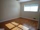 Well-lit bedroom featuring hardwood floors, a large window, and neutral wall paint at 3025 Ebenezer Rd., Se Rd, Conyers, GA 30094