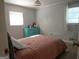 Comfortable bedroom with a soft pink bedspread, bright dresser and natural light from two windows at 3025 Ebenezer Rd., Se Rd, Conyers, GA 30094