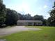 Charming one-story home featuring an attached garage, a large front yard and a paved driveway at 3025 Ebenezer Rd., Se Rd, Conyers, GA 30094