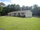 Lovely one-story house with a brick exterior, mature landscaping, and a well-maintained front lawn at 3025 Ebenezer Rd., Se Rd, Conyers, GA 30094