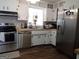 Galley kitchen featuring butcher block counters, stainless appliances and white cabinets at 3025 Ebenezer Rd., Se Rd, Conyers, GA 30094