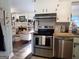 View of kitchen with stainless steel appliances open to a living space with fireplace and built-ins at 3025 Ebenezer Rd., Se Rd, Conyers, GA 30094