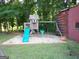 This playground features a slide, swings, and a charming playhouse, set on a bed of white gravel at 3025 Ebenezer Rd., Se Rd, Conyers, GA 30094