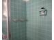Shower with light turquoise tiled walls and shower soap holder at 3025 Ebenezer Rd., Se Rd, Conyers, GA 30094