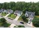 A high angle drone view showcases the homes in a Gathering-friendly neighborhood with tree-lined streets and well-kept yards at 3205 Anneewakee Falls Pkwy, Douglasville, GA 30135