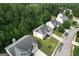An aerial shot shows the well-maintained home and lawn, surrounded by lush trees and a neighborhood street at 3205 Anneewakee Falls Pkwy, Douglasville, GA 30135