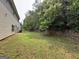 Expansive backyard featuring a stone retaining wall, providing privacy and character at 3205 Anneewakee Falls Pkwy, Douglasville, GA 30135