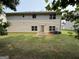 View of the backyard with a two-story house with a door and many windows at 3205 Anneewakee Falls Pkwy, Douglasville, GA 30135