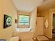 Sunlit bathroom featuring a soaking tub with window and a separate shower at 3205 Anneewakee Falls Pkwy, Douglasville, GA 30135