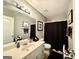 Clean bathroom with vanity, framed mirror, and shower with dark curtain at 3205 Anneewakee Falls Pkwy, Douglasville, GA 30135