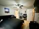 A view of a bedroom featuring a dark-themed king-sized bed, and a computer desk by the window at 3205 Anneewakee Falls Pkwy, Douglasville, GA 30135