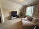 A spacious bonus room featuring comfortable seating, neutral carpet, and a large TV at 3205 Anneewakee Falls Pkwy, Douglasville, GA 30135
