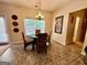 Bright breakfast nook area with a round table, wicker chairs, and a view of the backyard at 3205 Anneewakee Falls Pkwy, Douglasville, GA 30135