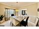 Formal dining room with large table, neutral color palette, and natural light from the window at 3205 Anneewakee Falls Pkwy, Douglasville, GA 30135
