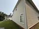 Side view of the house showing its siding and multiple windows, complemented by green grass at 3205 Anneewakee Falls Pkwy, Douglasville, GA 30135