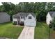 Exterior shot of home with traditional curb appeal, a two-car garage and a manicured lawn and landscaping at 3205 Anneewakee Falls Pkwy, Douglasville, GA 30135