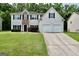 Charming two-story home with a well-manicured lawn, attached two-car garage, and traditional design elements at 3205 Anneewakee Falls Pkwy, Douglasville, GA 30135