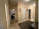 Neutral hallway has carpet, white doors, and decorative wall hangings at 3205 Anneewakee Falls Pkwy, Douglasville, GA 30135