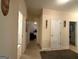 Neutral hallway has carpet, white doors, and decorative wall hangings at 3205 Anneewakee Falls Pkwy, Douglasville, GA 30135