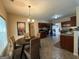Open kitchen with stainless appliances, dark cabinetry, and breakfast nook area with backyard views at 3205 Anneewakee Falls Pkwy, Douglasville, GA 30135