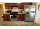 Kitchen featuring stainless appliances, dark cabinetry, and a tiled floor at 3205 Anneewakee Falls Pkwy, Douglasville, GA 30135
