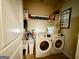 Functional laundry room featuring modern washer, dryer, storage, and shelving at 3205 Anneewakee Falls Pkwy, Douglasville, GA 30135