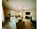 Cozy living room featuring comfortable sectional sofa, mounted television, and desk area at 3205 Anneewakee Falls Pkwy, Douglasville, GA 30135