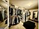 Bright and airy walk-in closet featuring a mirror and ample storage with shelves and hanging racks at 3205 Anneewakee Falls Pkwy, Douglasville, GA 30135